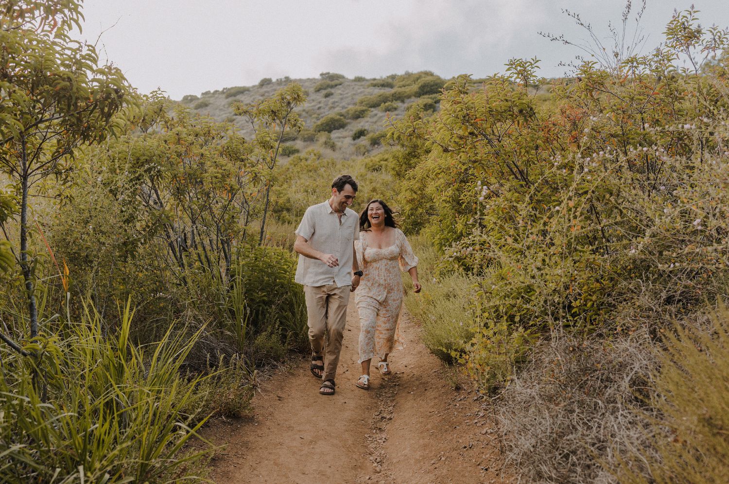 E. Noelle Photography couple engagement in the Los Angeles Malibu hills running through trails laughing