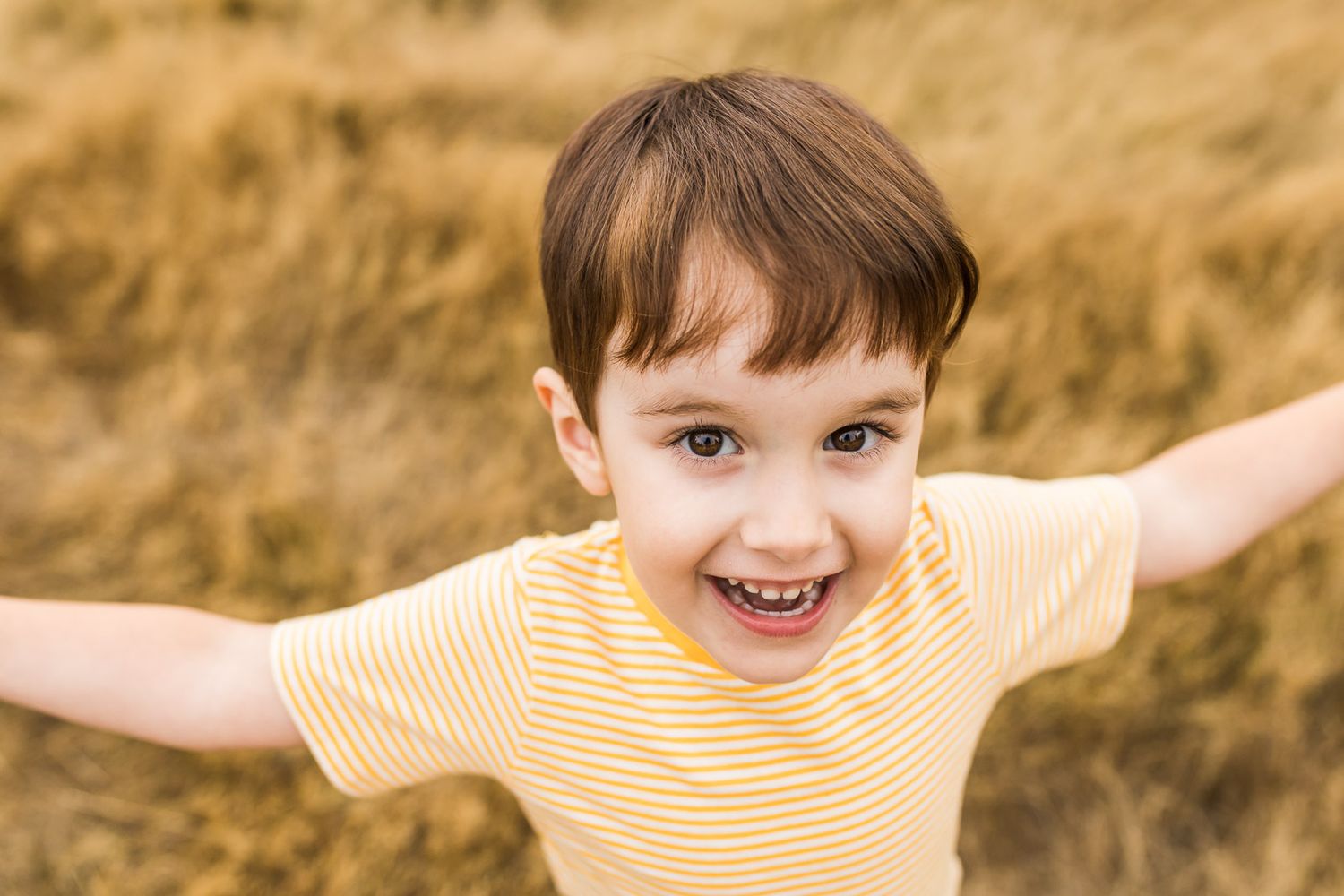 Candid portrait of a smiling redheaded little boy
