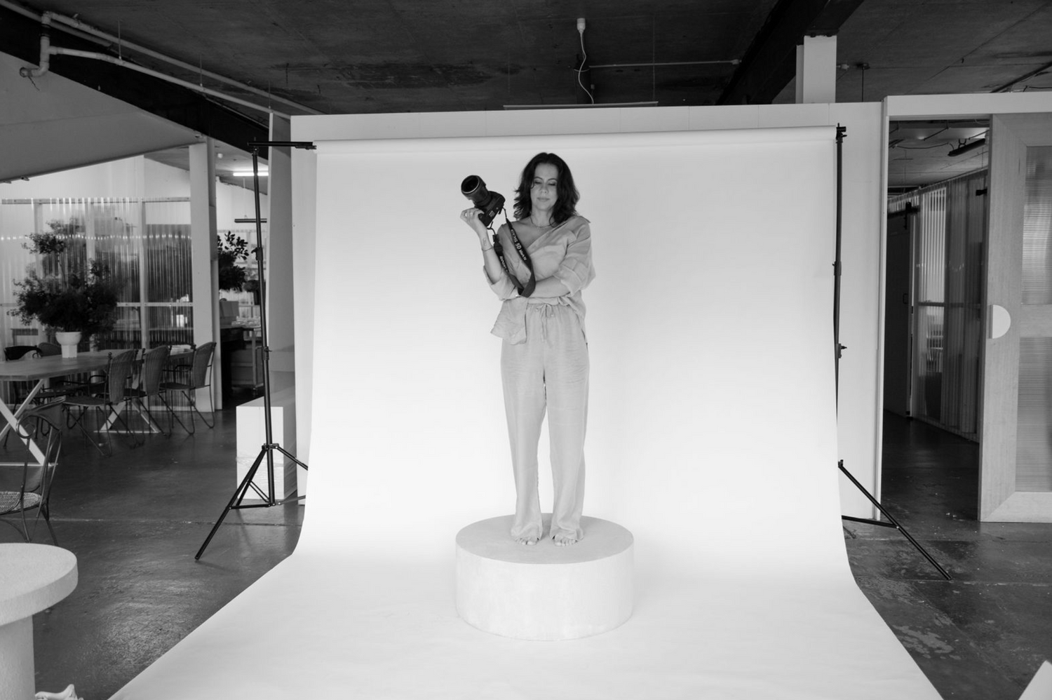 Photography studio setup with white backdrop and professional lighting equipment.