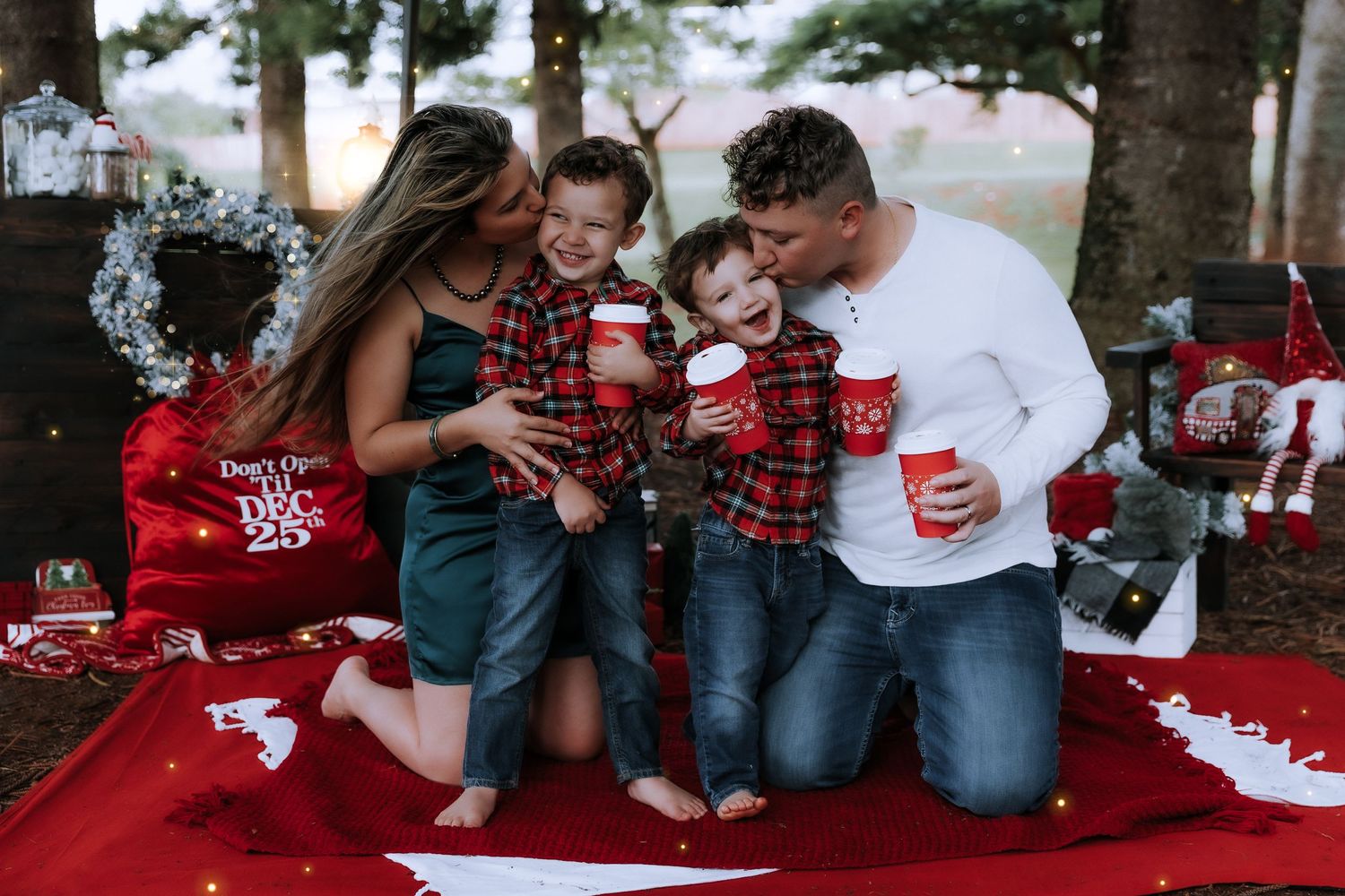 Family holiday photo session with buffalo plaid and Christmas decorations.