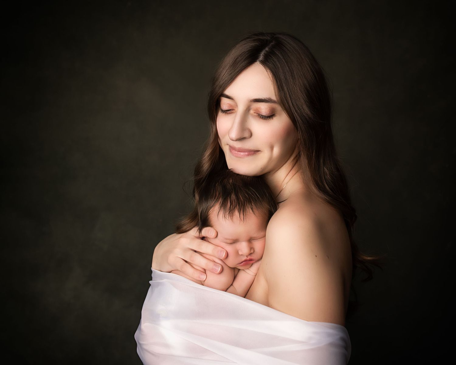 mother wrapped with newborn baby fine art motherhood portrait