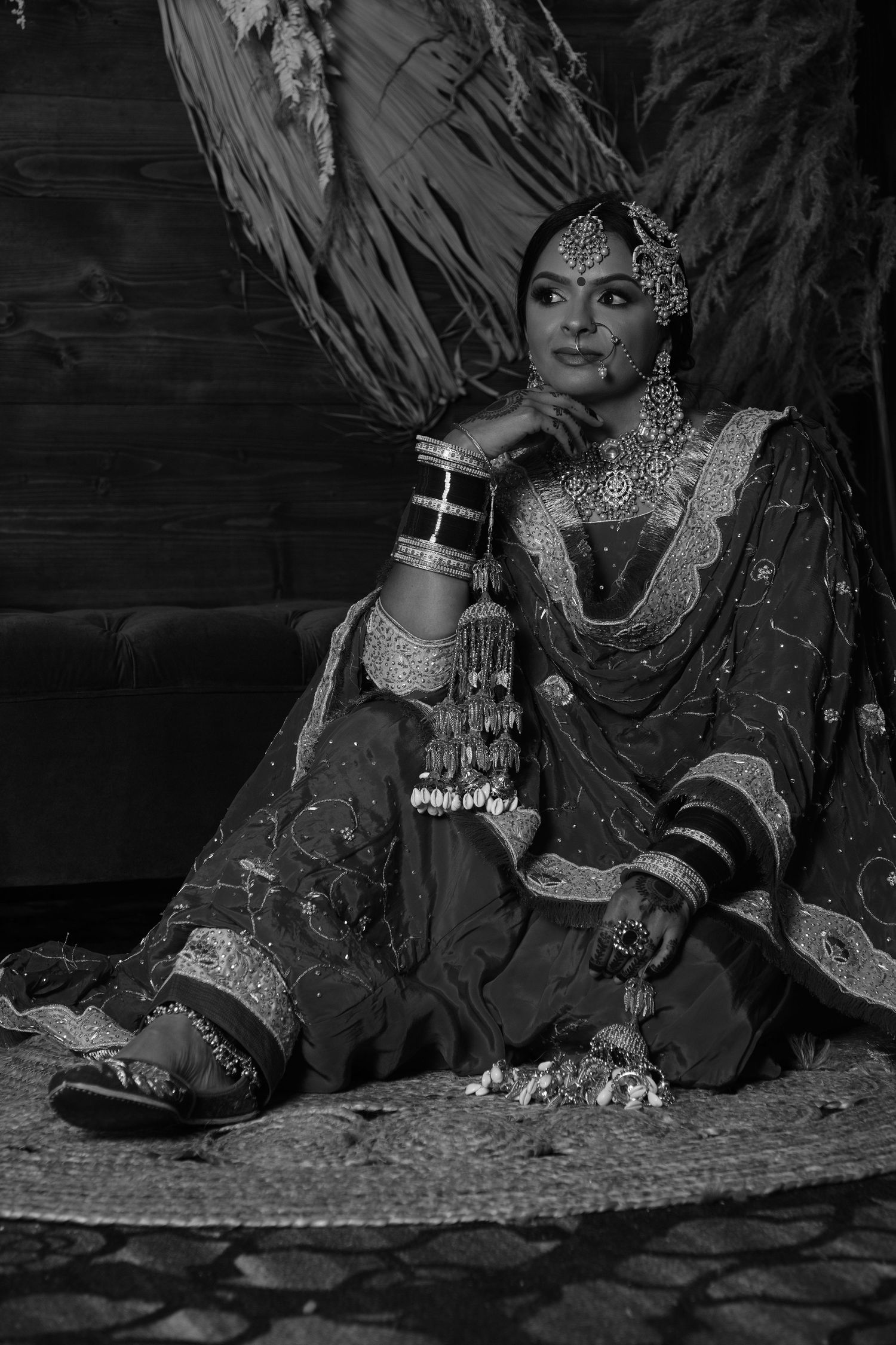 Black and white portrait showcasing traditional South Asian bridal jewelry and attire.