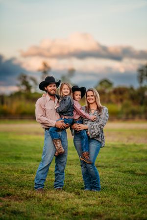 western family of 4 posing at the camera during golden hour