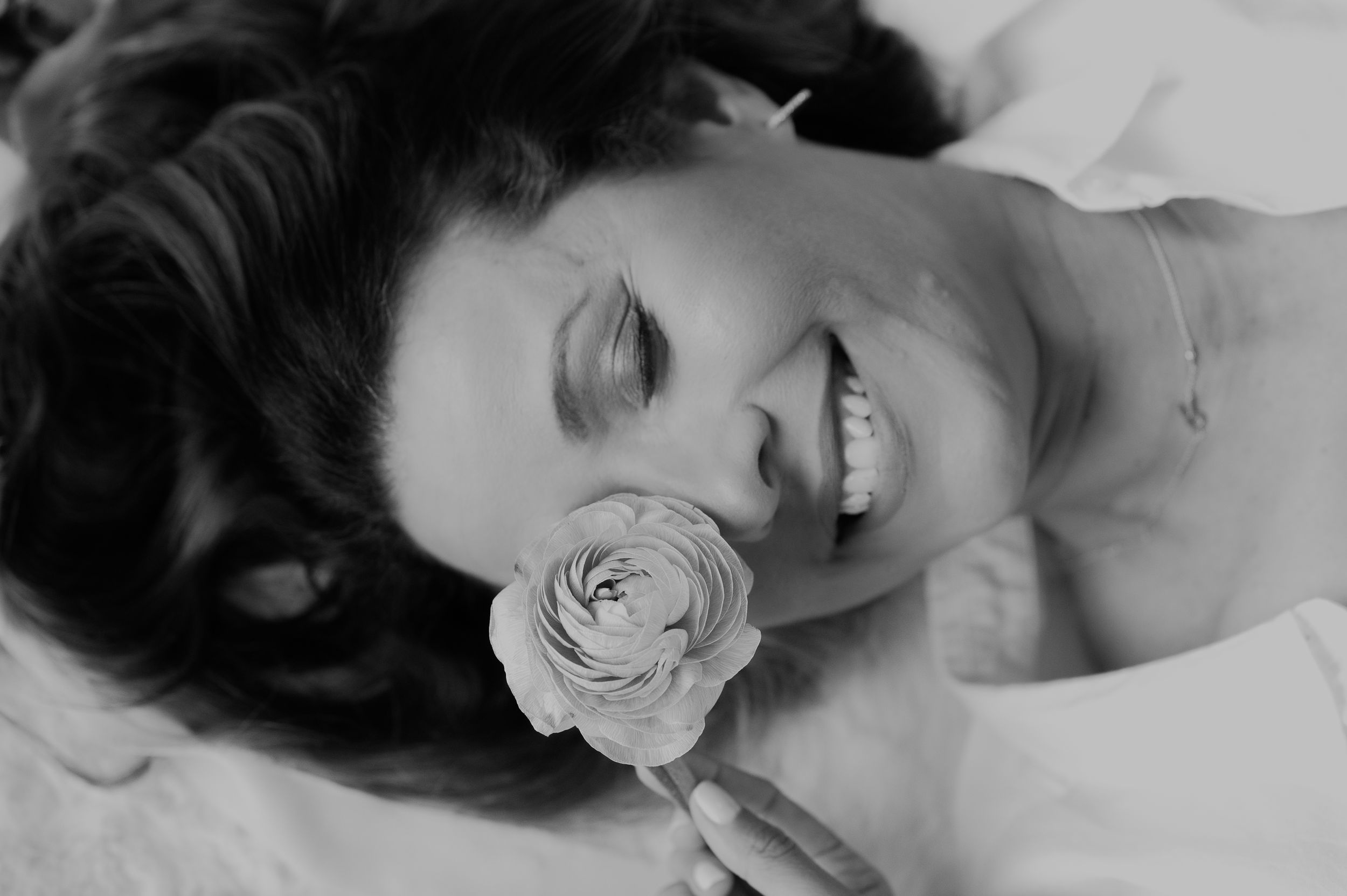 Black and white artistic portrait with a single rose creating a romantic mood.