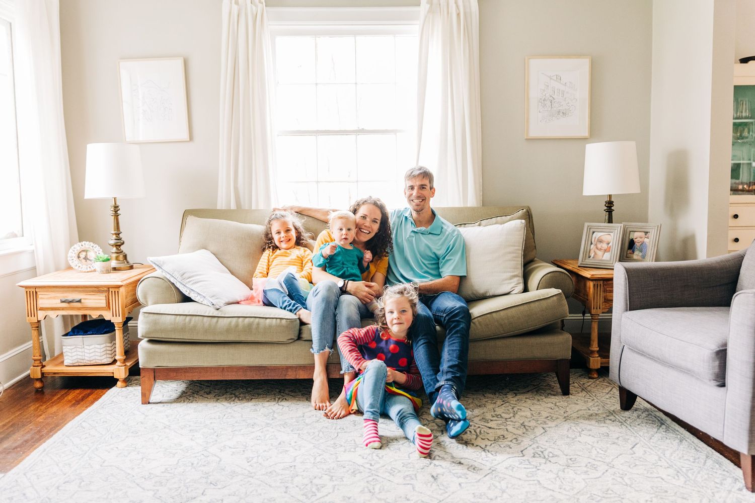 A family wearing colorful and patterned outfits in their Charlotte living room