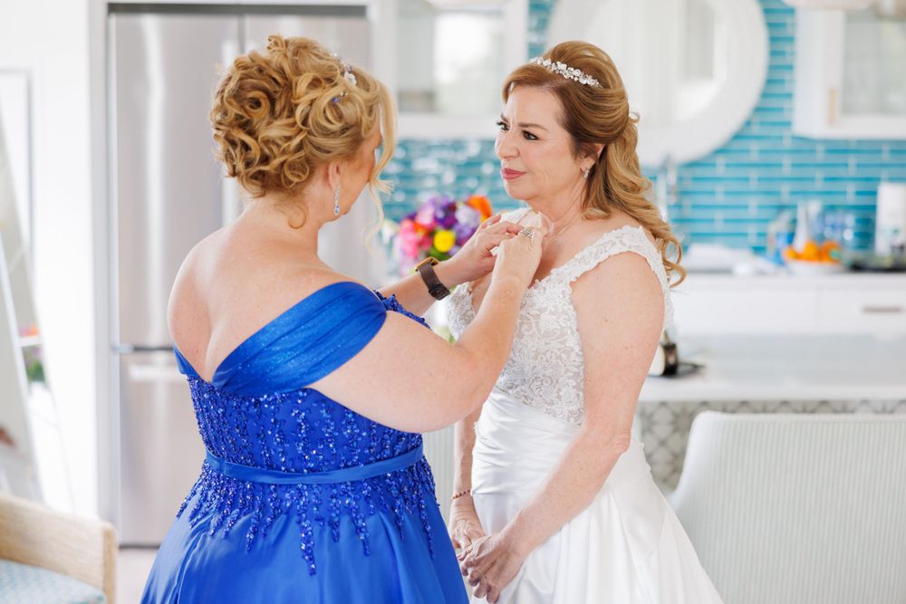 Final wedding preparations in a modern kitchen with white and turquoise accents.