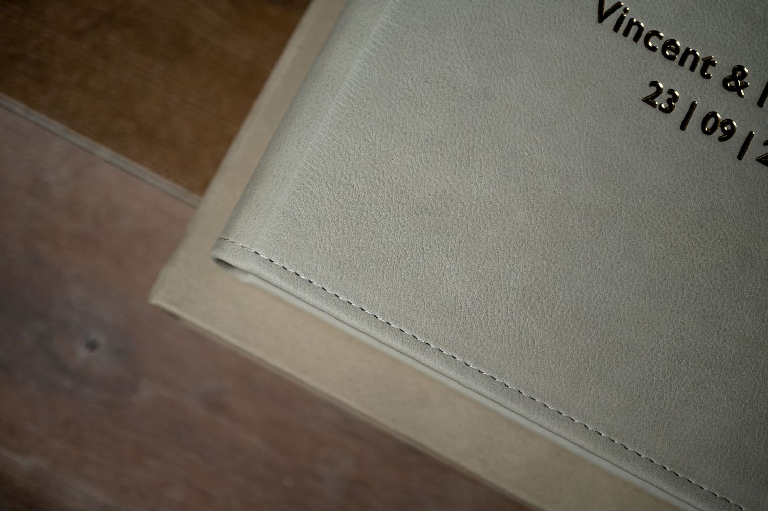 Close-up view of photo album details with text on a wooden background.