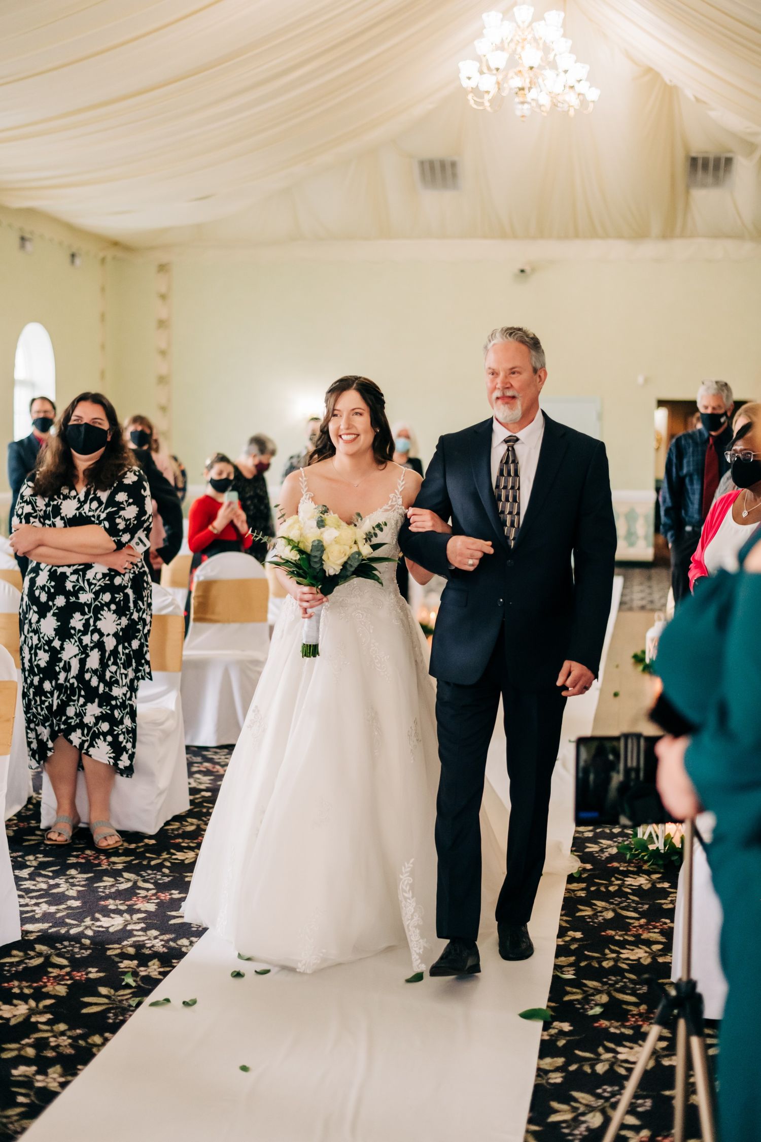 bride and her father walking down the aisle during wedding cermony