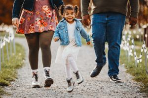 The sun shines behind the Harrington family as they walk towards the camera at the Cincinnati Nature Center.