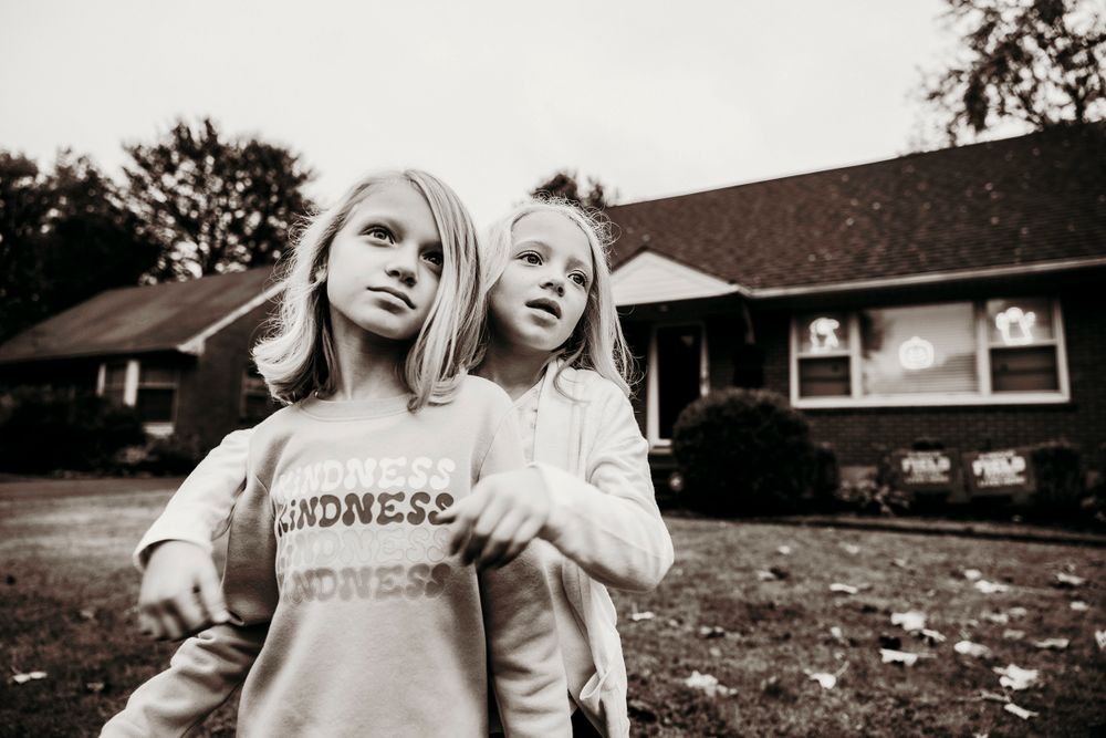 The Walraven sisters stand in front of their house in Louisville, Kentucky.