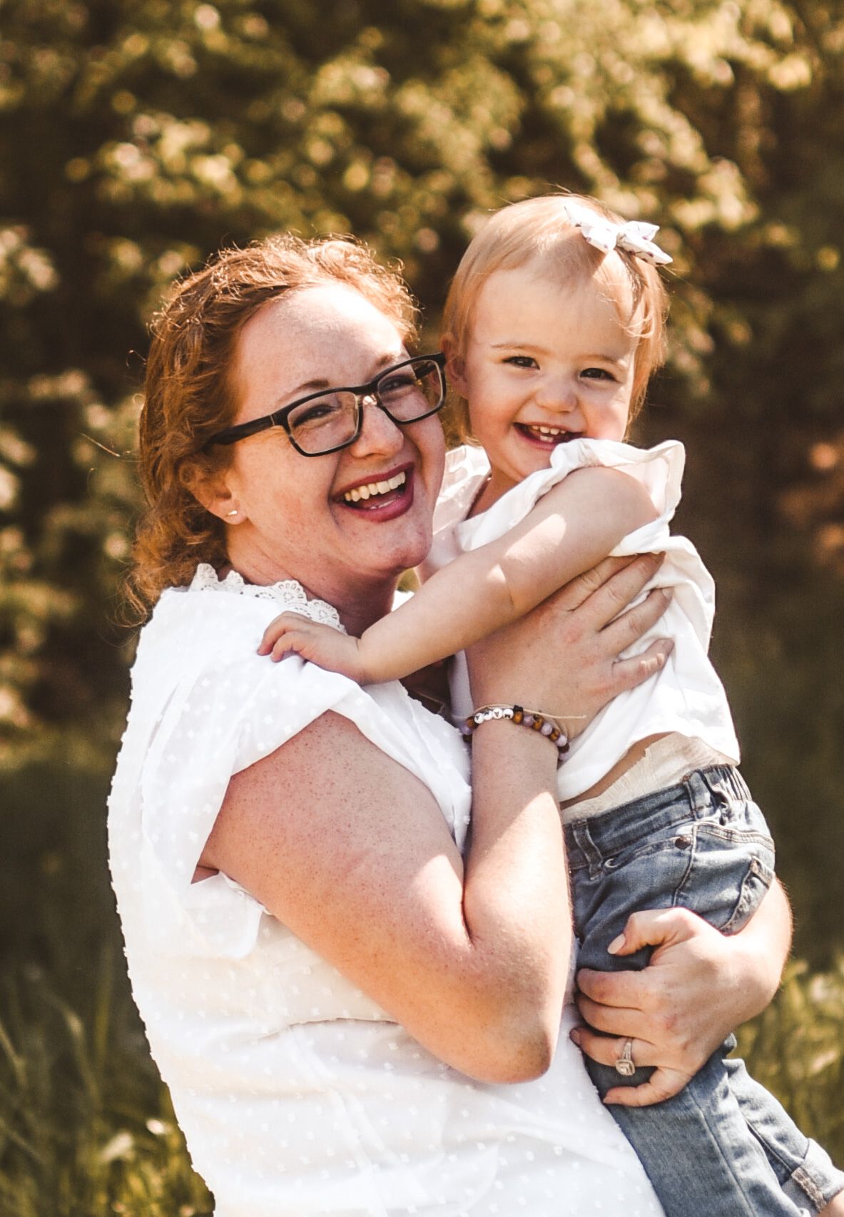 Joyful outdoor portrait with natural sunlit background in summer.