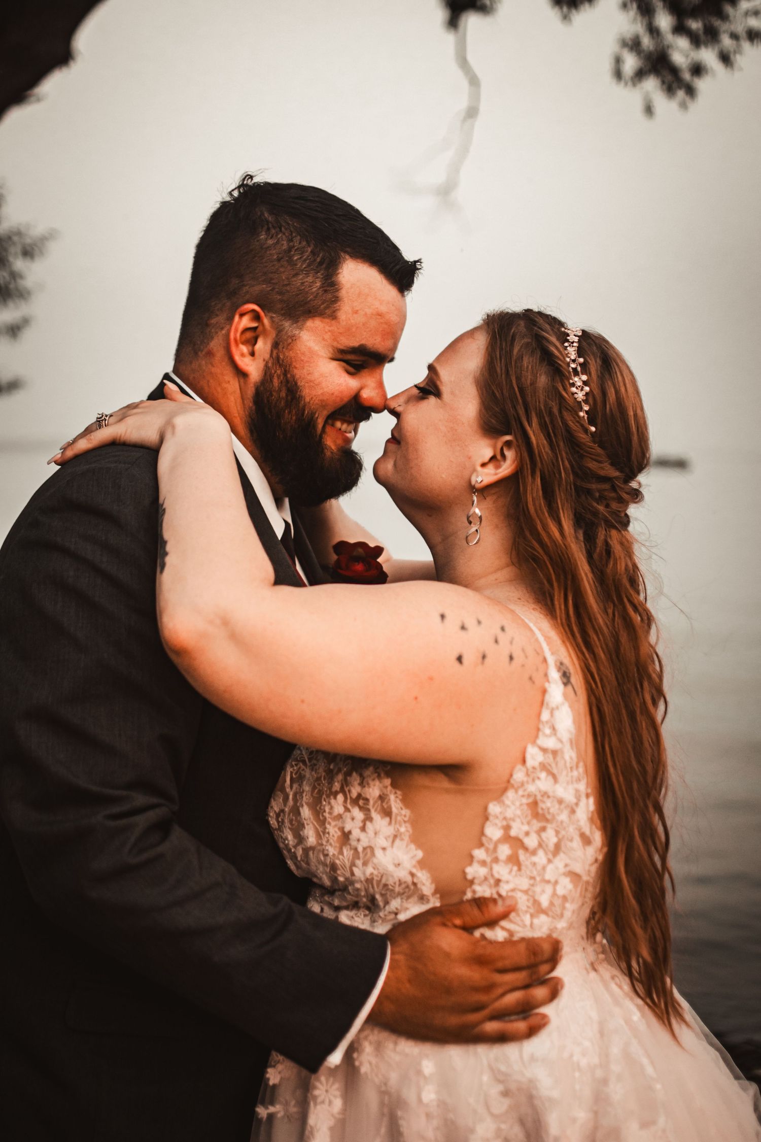 Intimate wedding portrait with couple in formal attire sharing a tender moment.