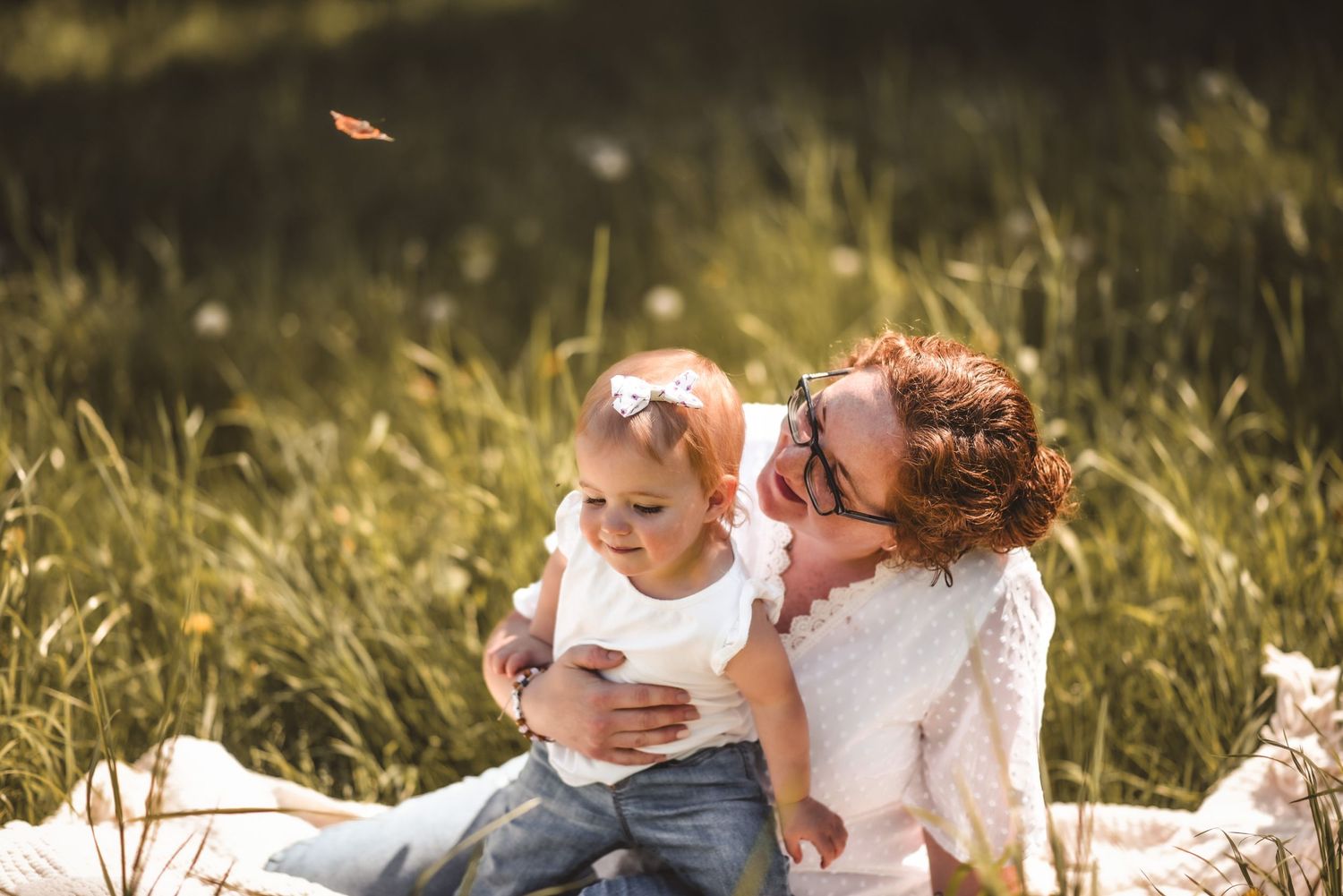 Sweet candid moment captured during outdoor photoshoot in tall grass.