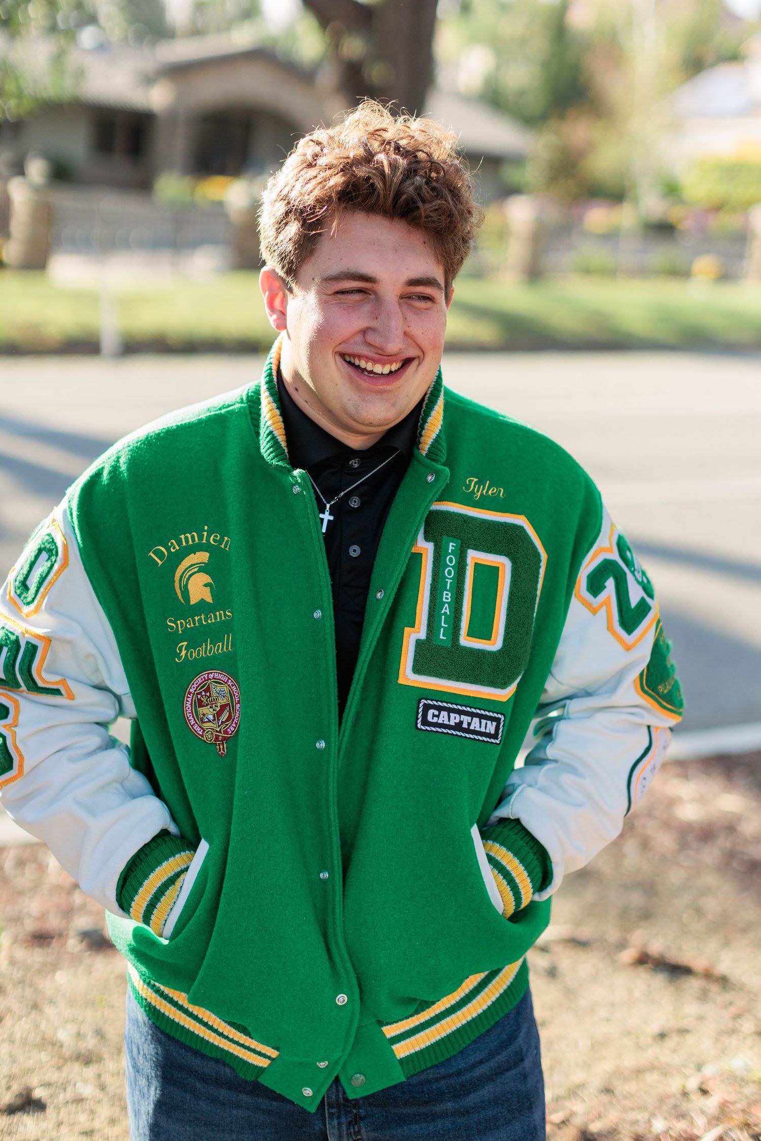 Smiling Senior men in varsity football letterman jackets