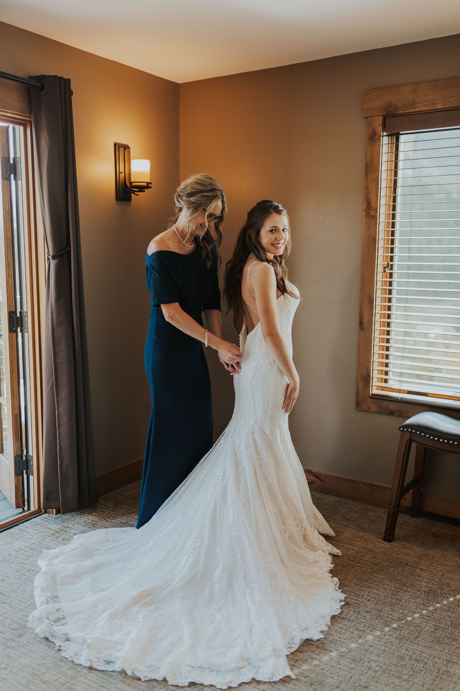 Bride zipping up dress Estes Park, Colorado wedding photographer
