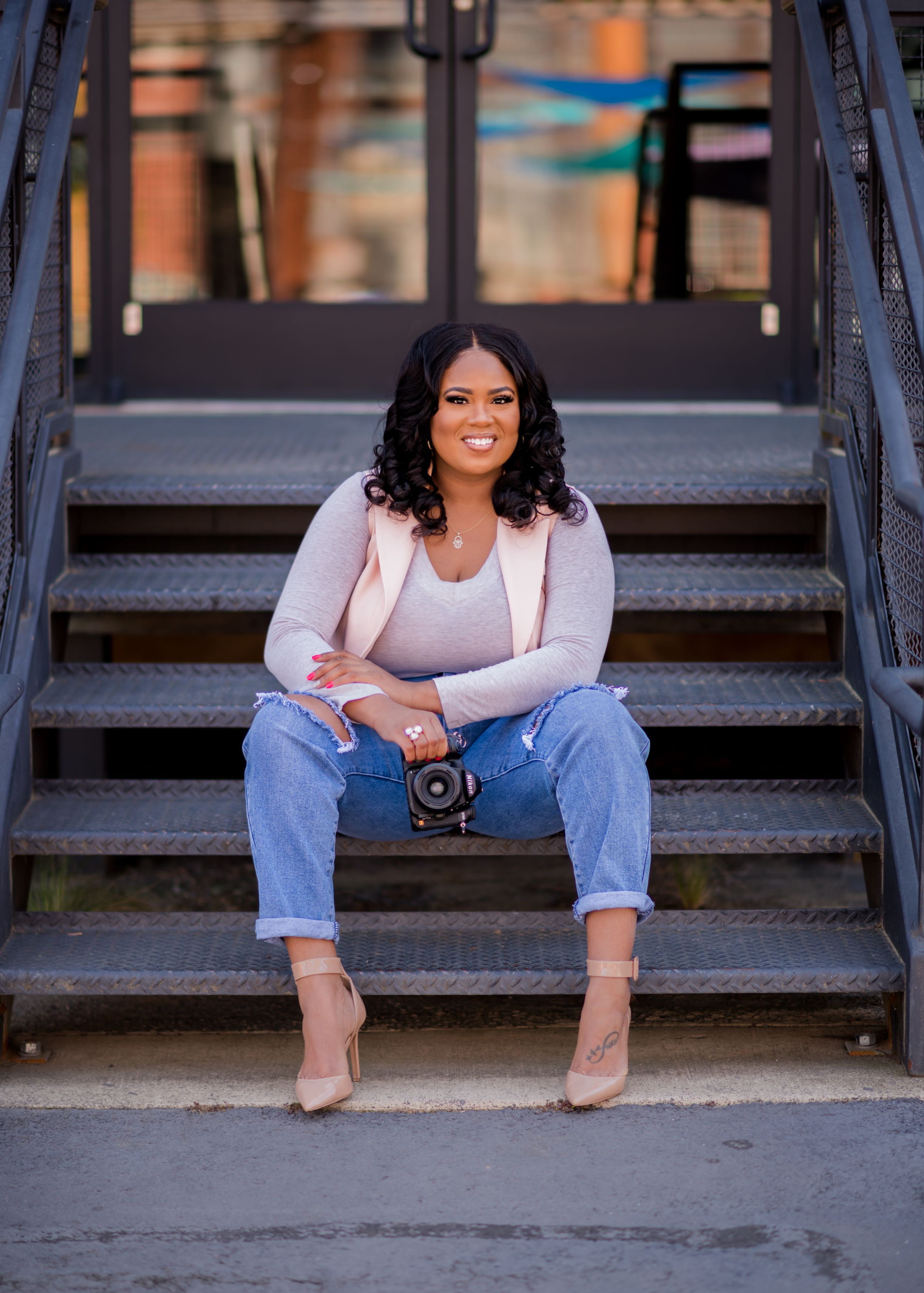 Kia Wiggins female photographer sitting on a step in camp north end