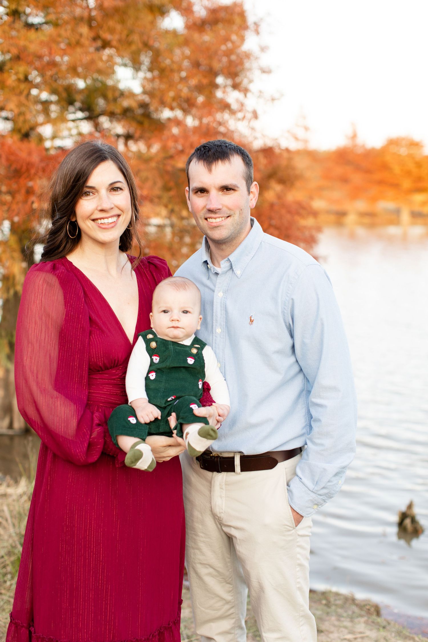Beautiful family portrait by the water with burgundy dress and festive fall colors.