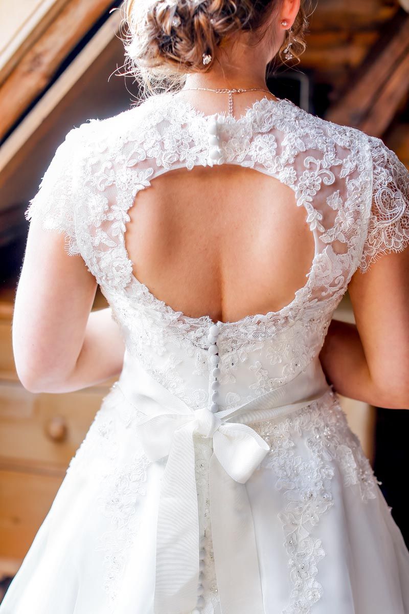 Back view of wedding dress showing intricate lace detailing and keyhole back design.