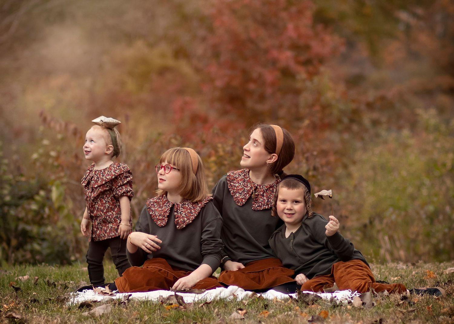 fall kids looking on the leaves falling