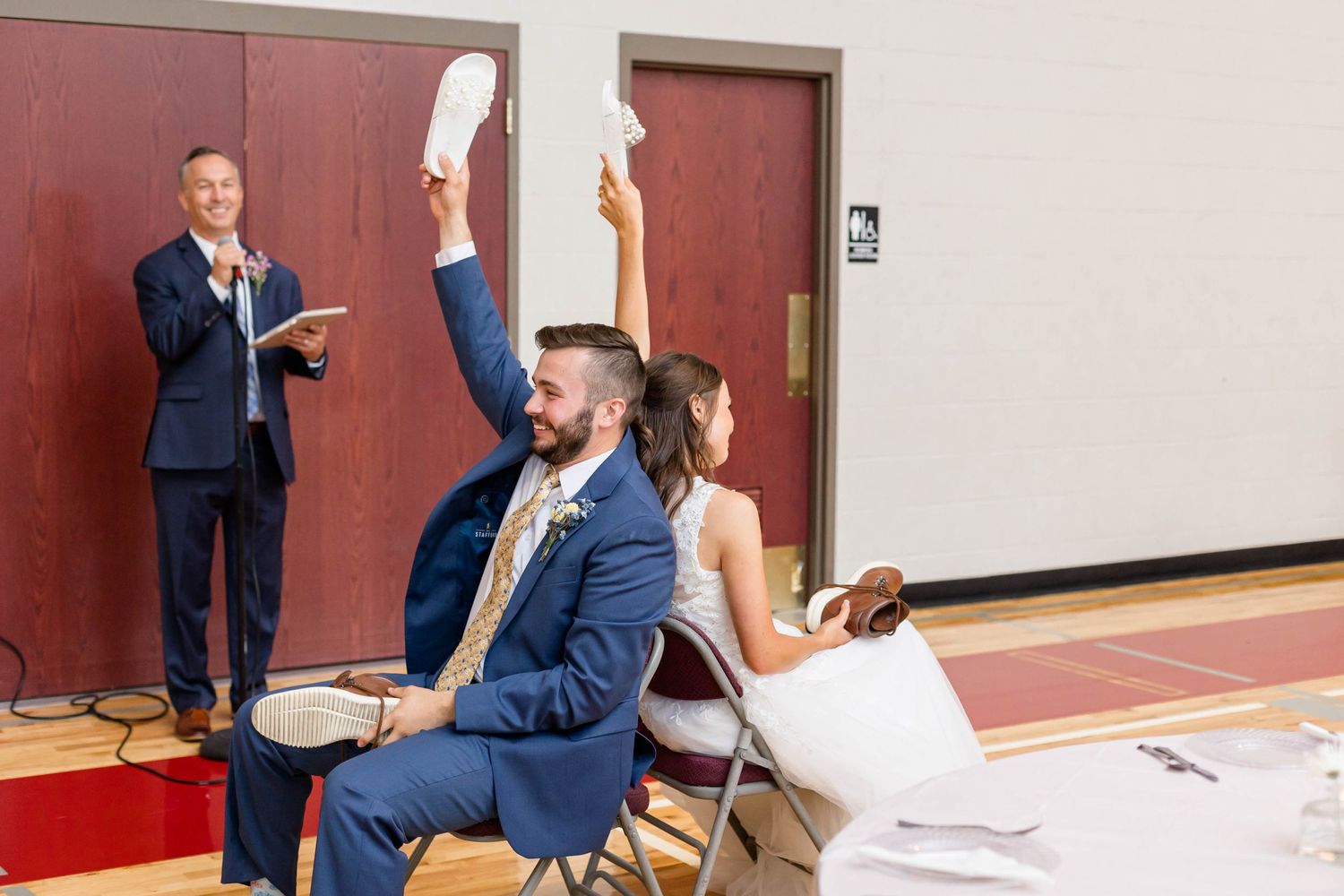 bride and groom play the shoe game at reception