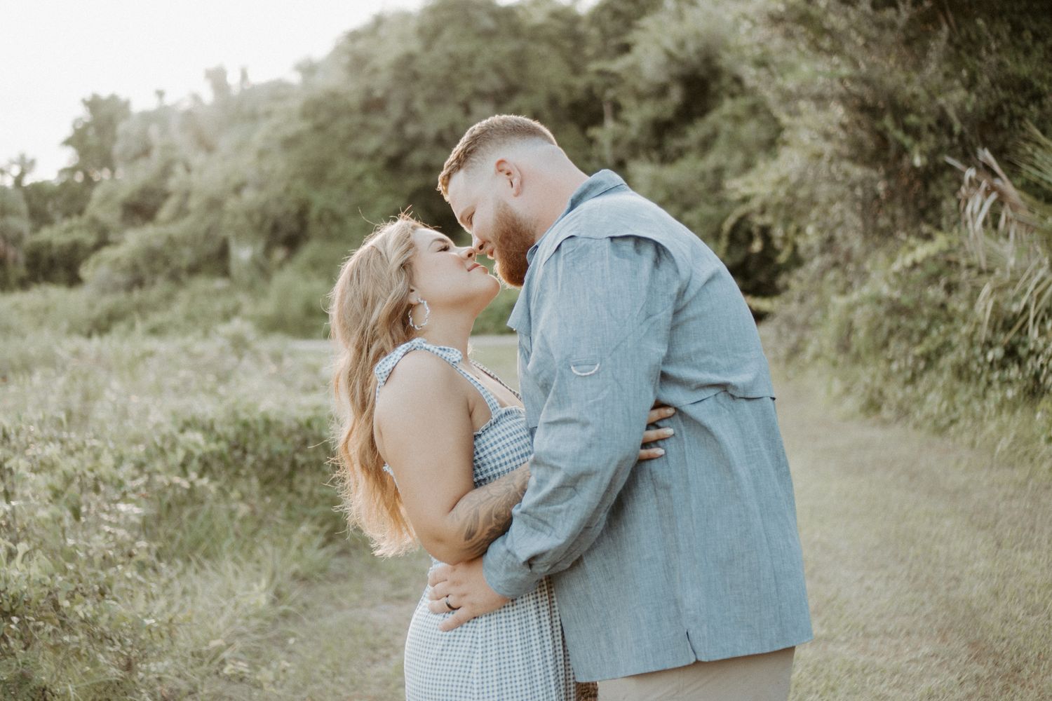 Couple at Gemini Springs Park kissing at sunset