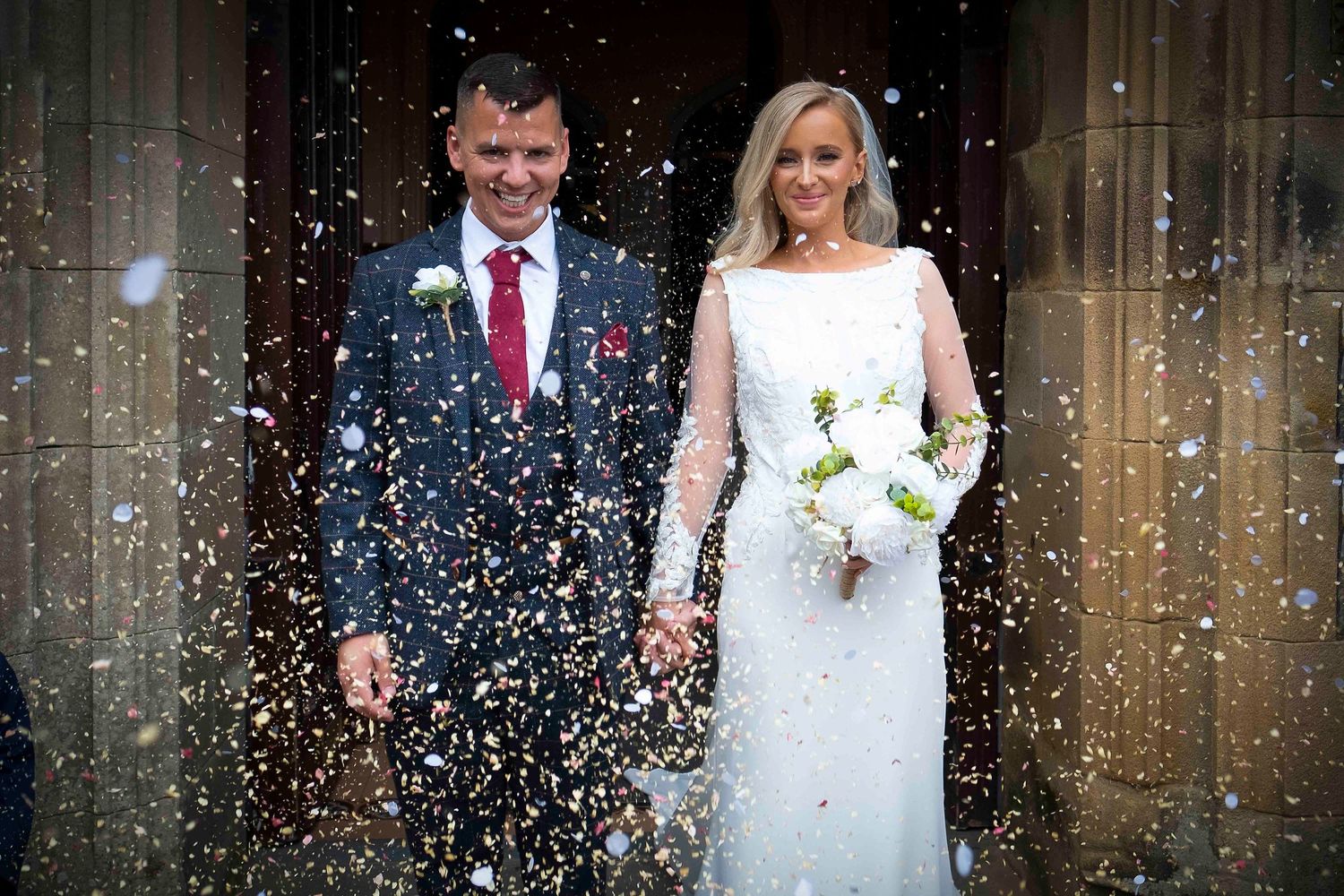 Confetti is thrown for Joe & cathleen  at this stunning Lake District wedding at Levens Hall.