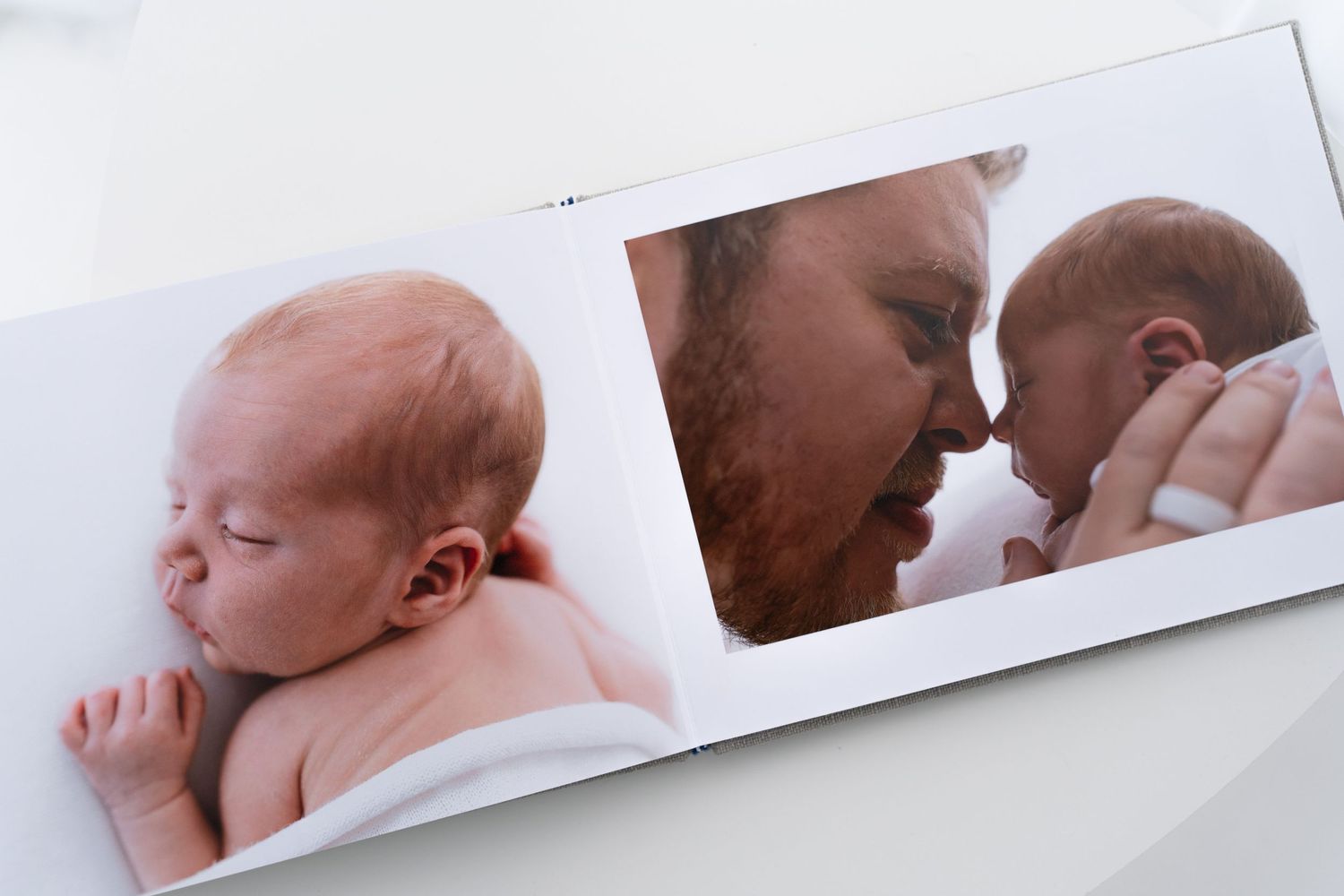 Baby photo album spread showing tender moments of newborn care.