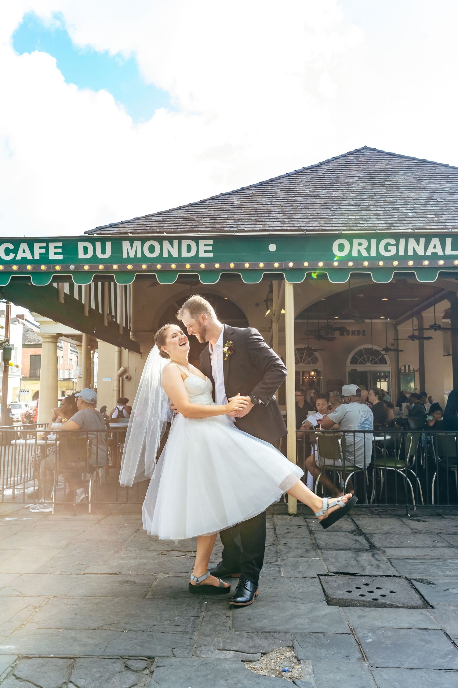 A romantic dance pose in front of the iconic Cafe Du Monde in New Orleans.