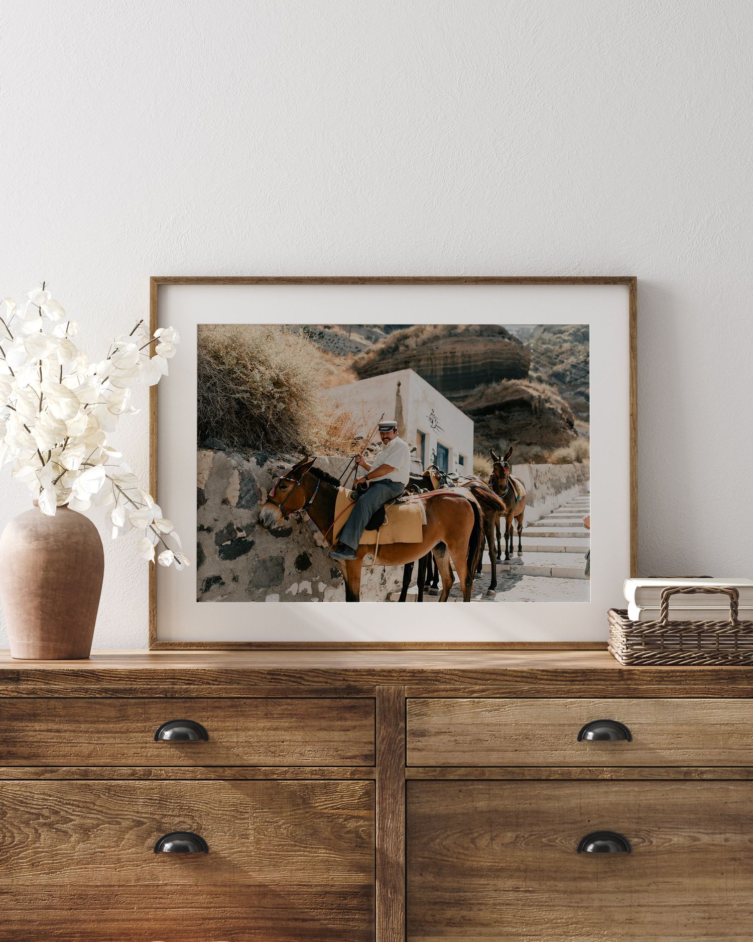 Vintage-style framed photograph of donkeys outside a whitewashed building.
