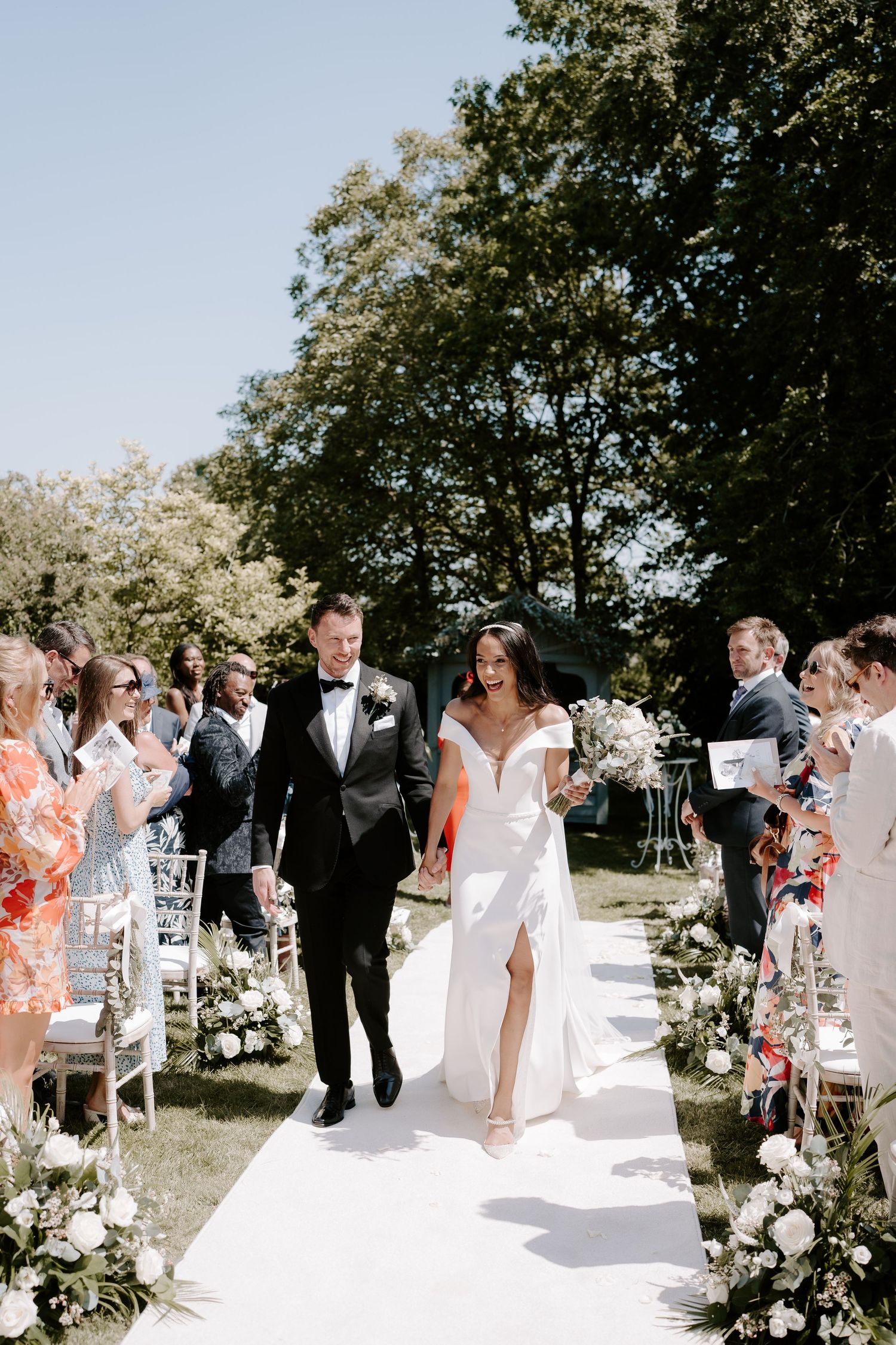 bride-and-groom-coming-down-aisle-stockton-house-outdoor-wedding-ceremony