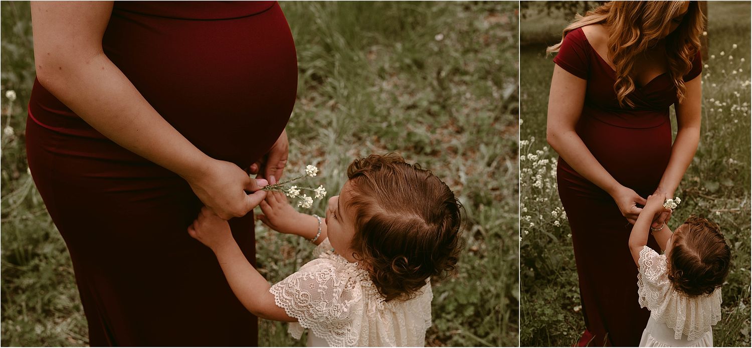 Mother and toddler share a tender moment outdoors wearing complementary burgundy and cream outfits.