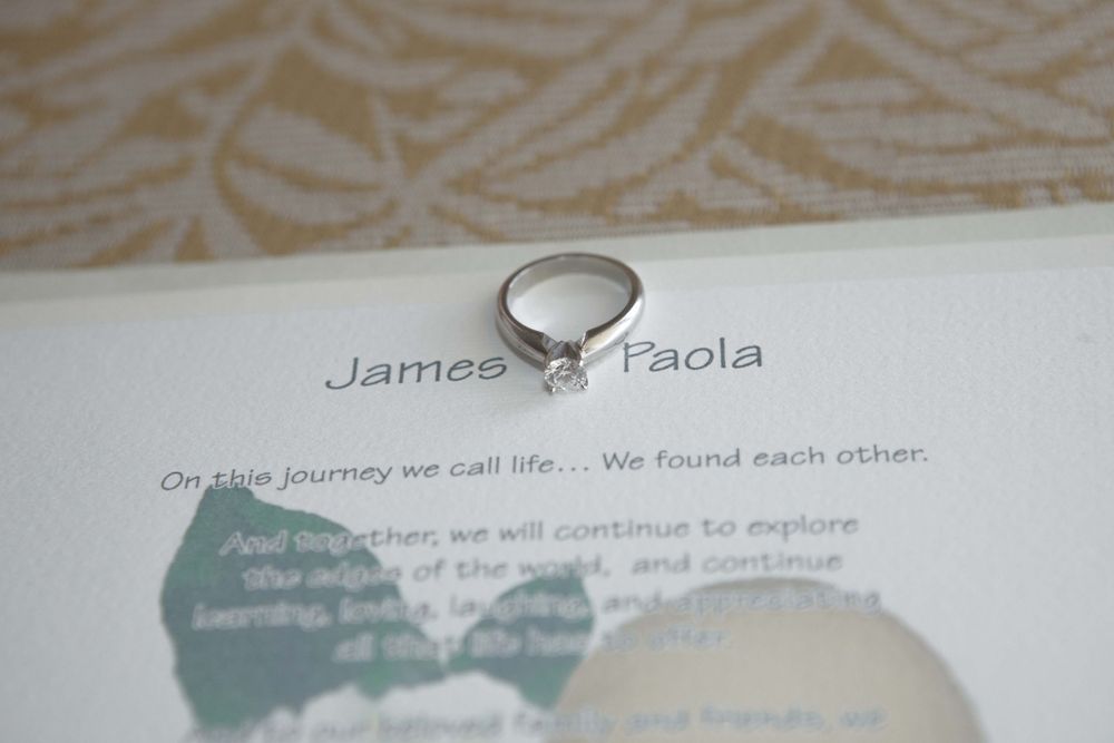 A photo album displays wedding-themed pages with handwritten text and decorative elements against a white background.