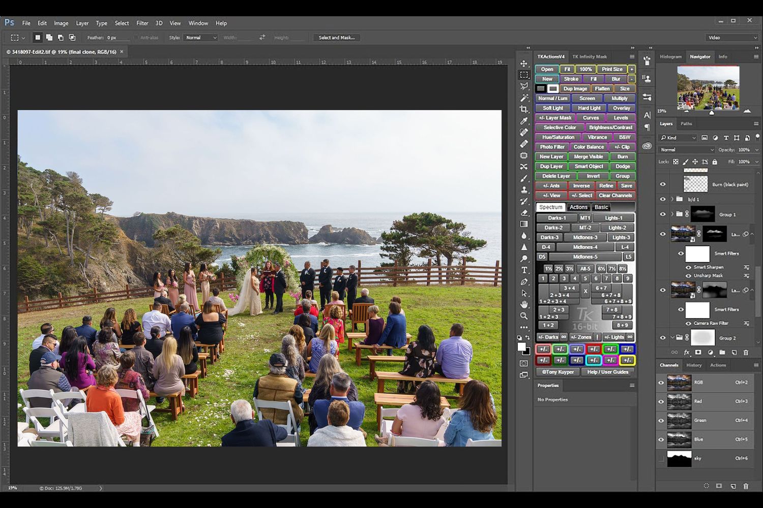 People gathered for an outdoor event along a coastal path with the ocean view visible in Photoshop's editing interface.