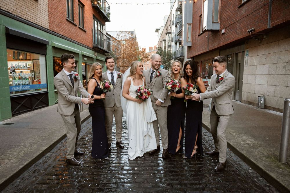 Temple bar photographer. Bridal party are celebrating with each other. Best wedding photographer in Ireland. Award winning photographer.