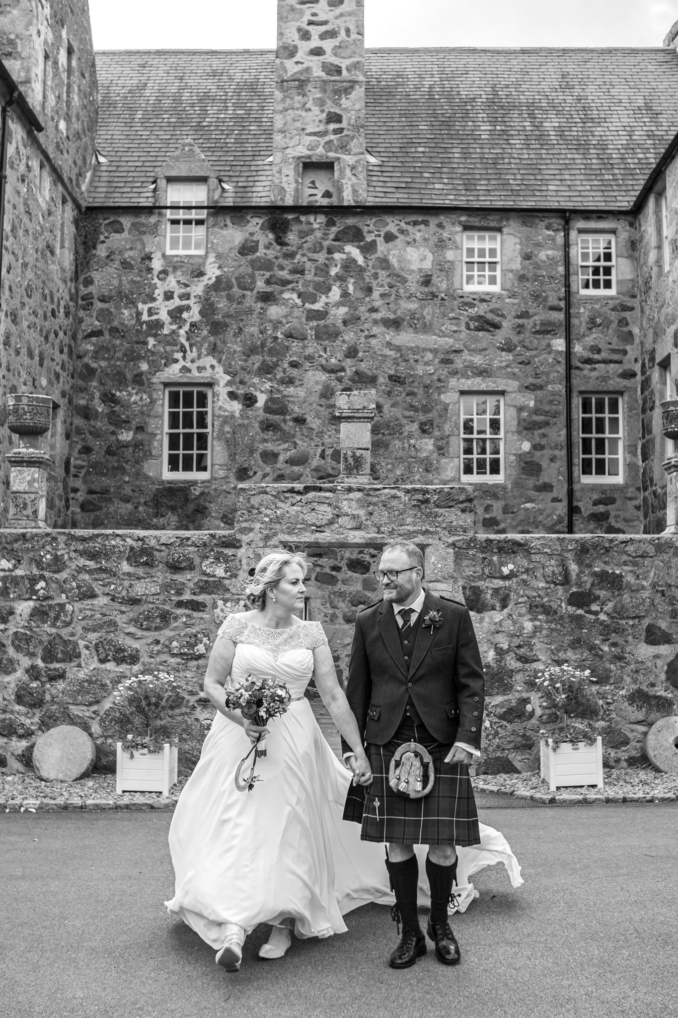 bride and groom in black and white outside the church after their marriage ceremony by wedding photographer aberdeen