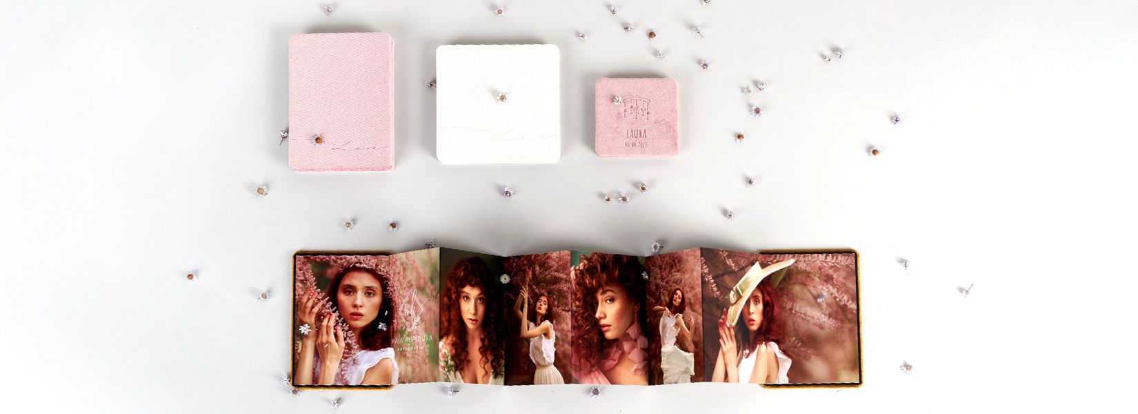 Collection of pink and white photo boxes with floral accents.