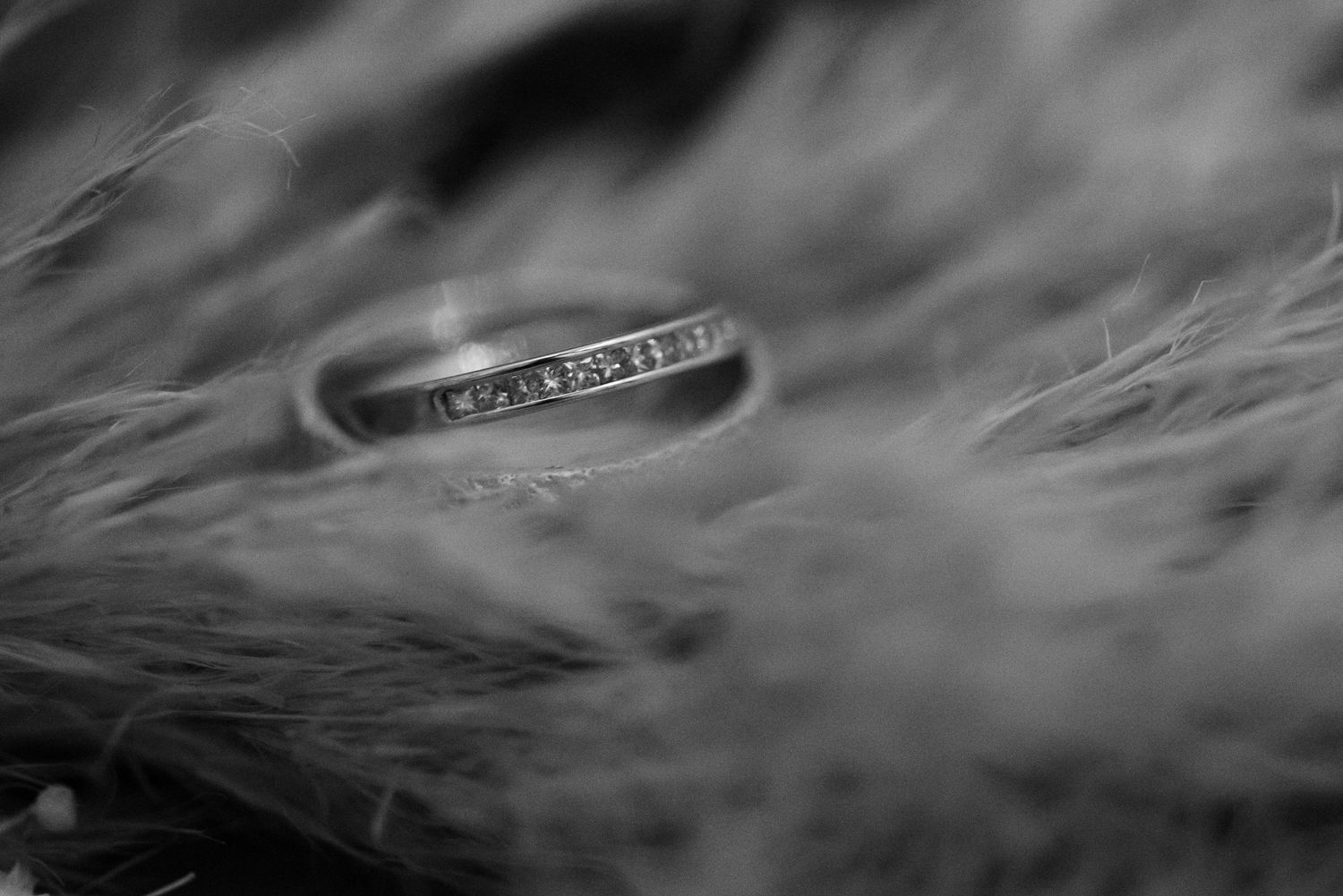 Wedding rings photographed in dramatic black and white with smoky effects.