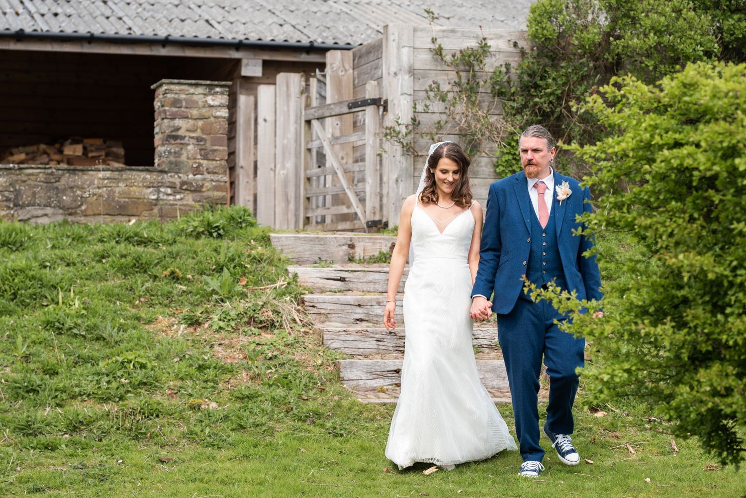 A stone building exterior provides a romantic backdrop for wedding photography.