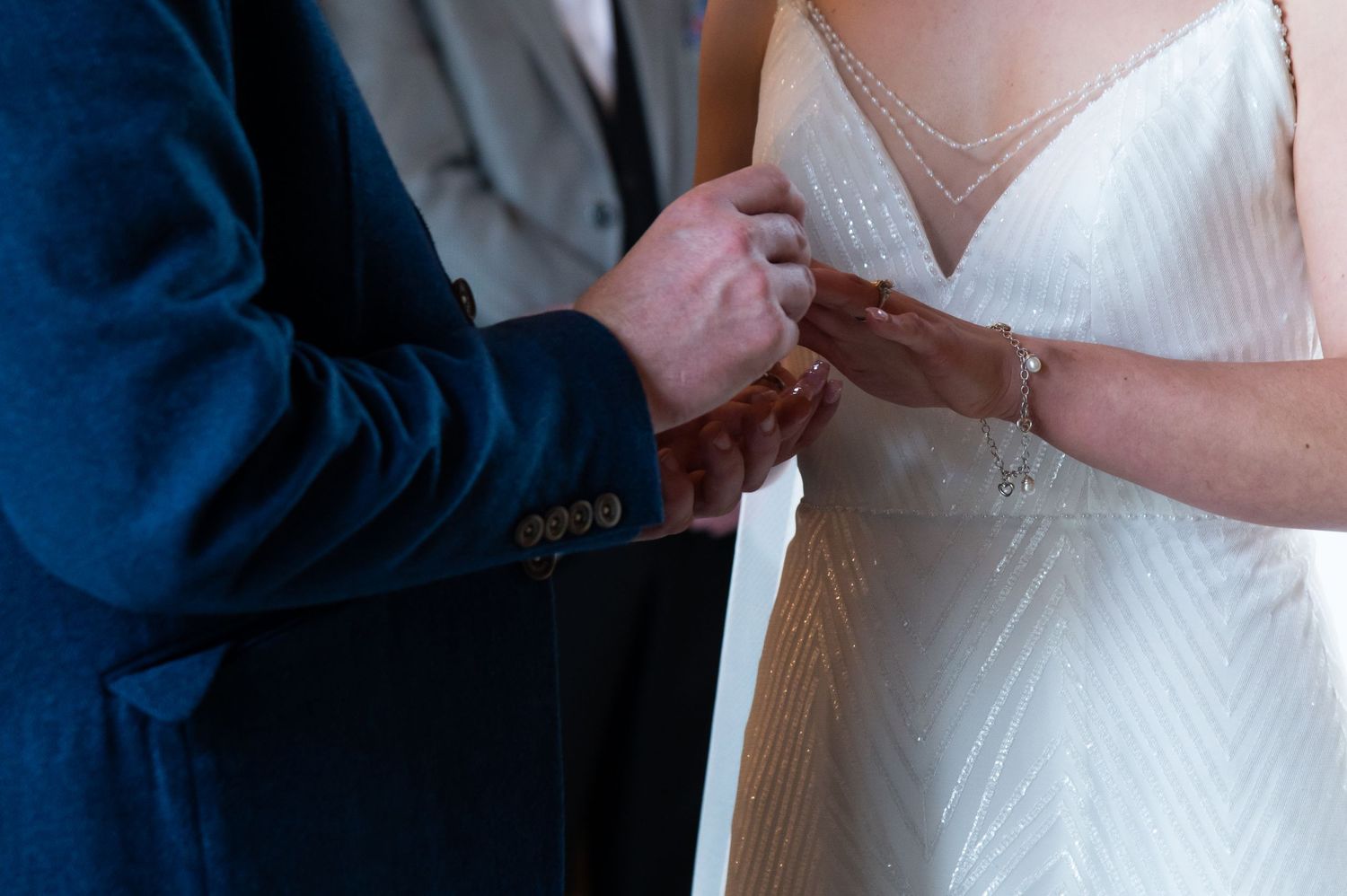 Exchange of rings during an intimate wedding ceremony.