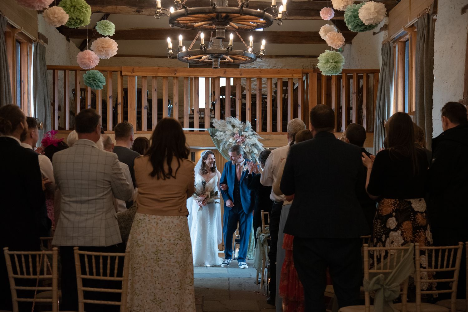An elegant wedding reception venue with chandeliers and decorative paper lanterns.