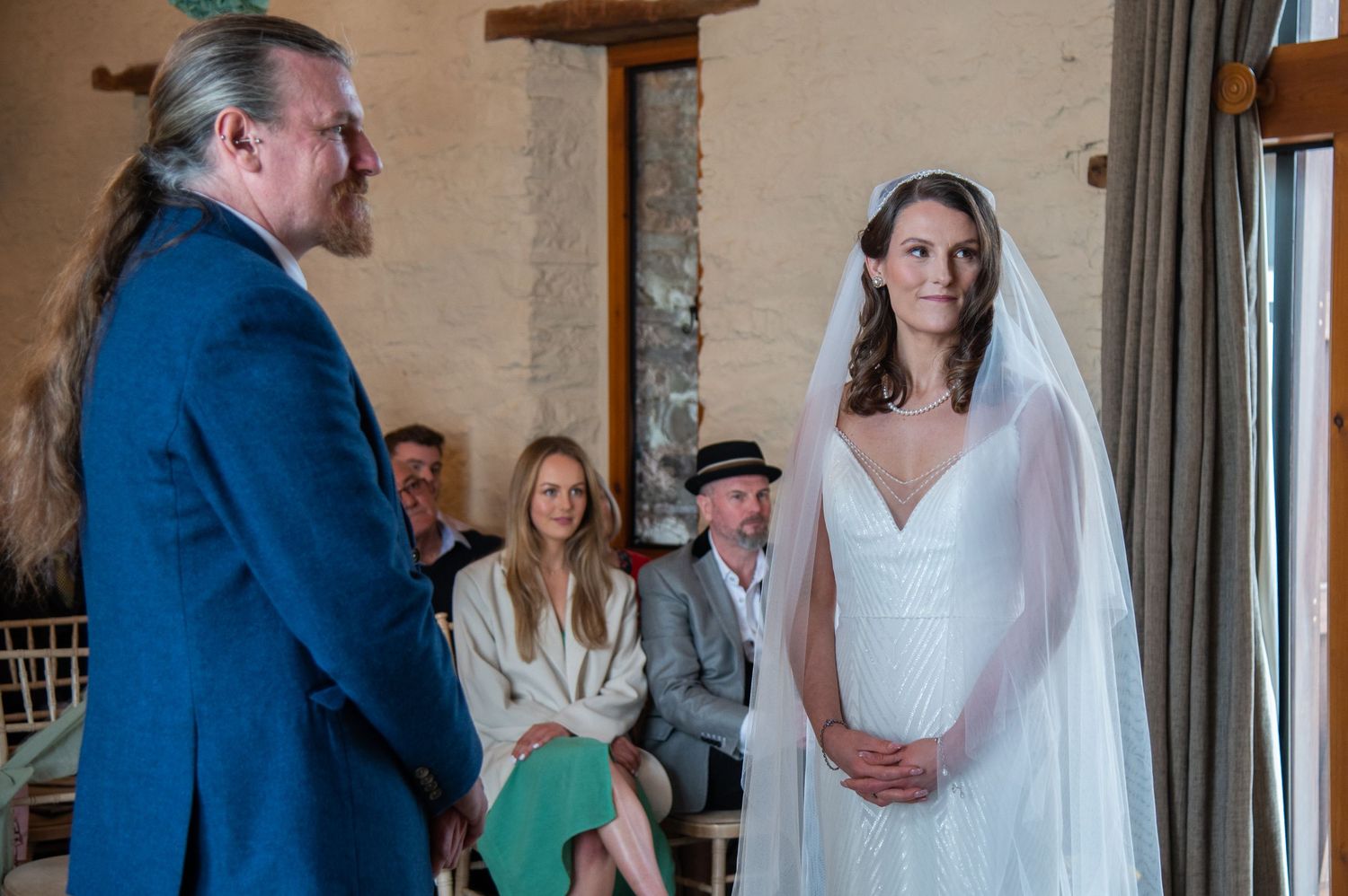 A wedding ceremony moment captured in an indoor venue with natural light.