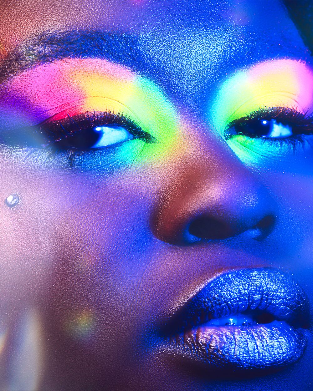 Artistic portrait with rainbow holographic lighting effects creating a dreamy atmosphere.