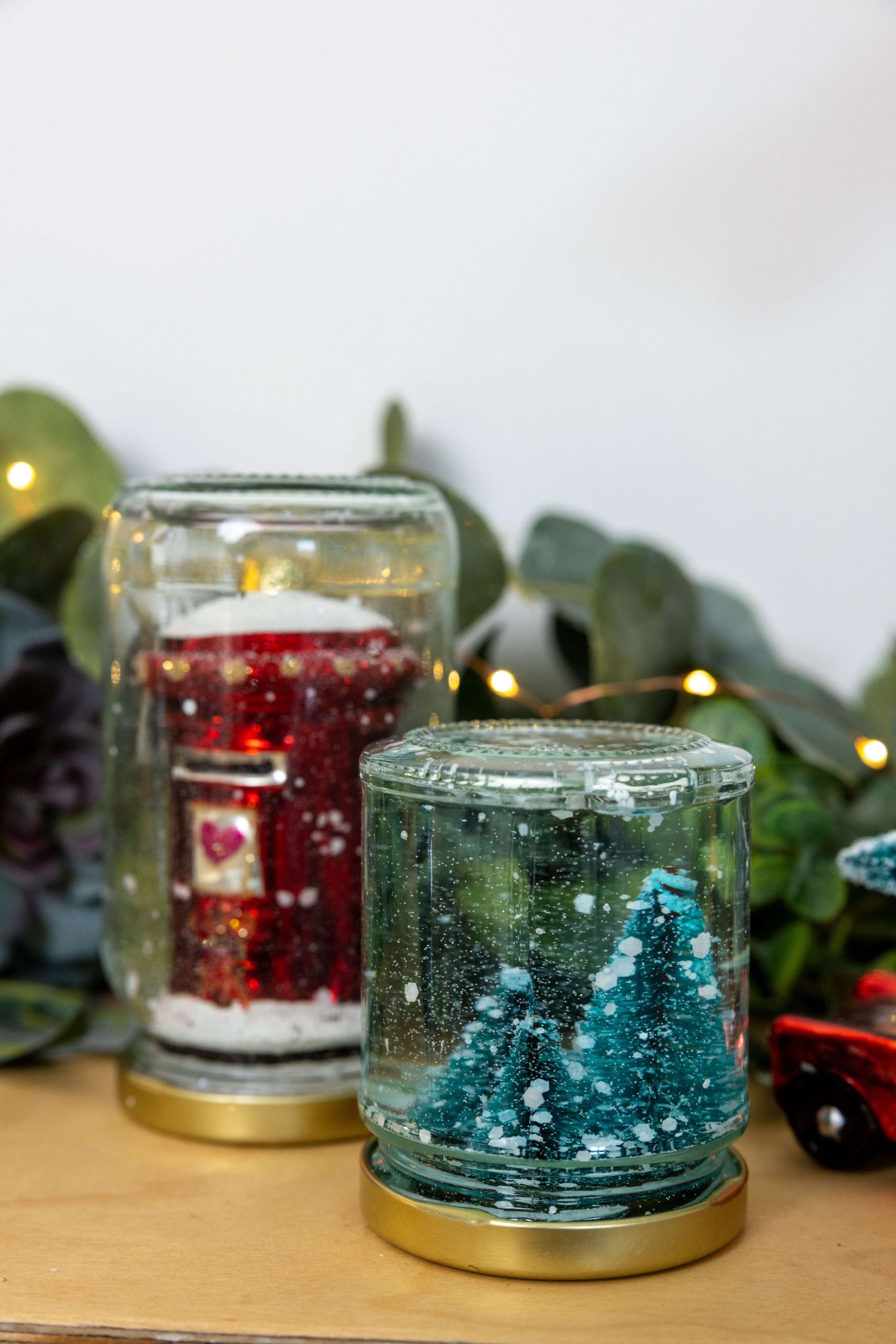 two snow globes sat on a shelf that jess made for an Amazon advert shot in her home