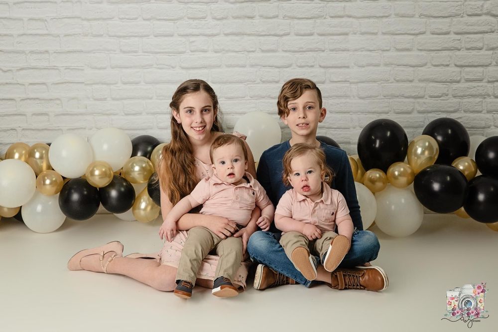 Portrait setup with balloon garland and decorative background for family photo.