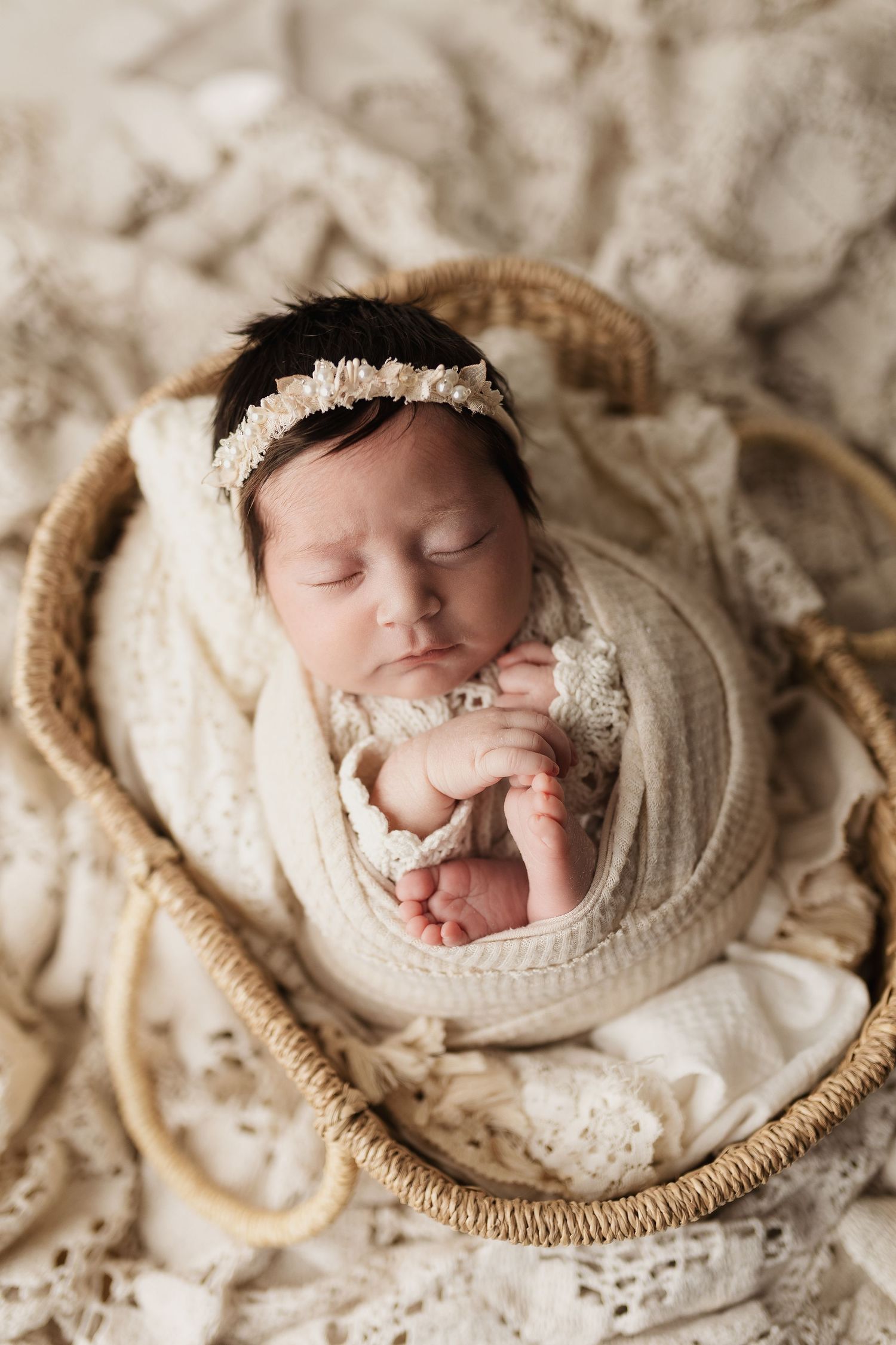 Mother and newborn share tender moments in white outfits against sunlit windows.