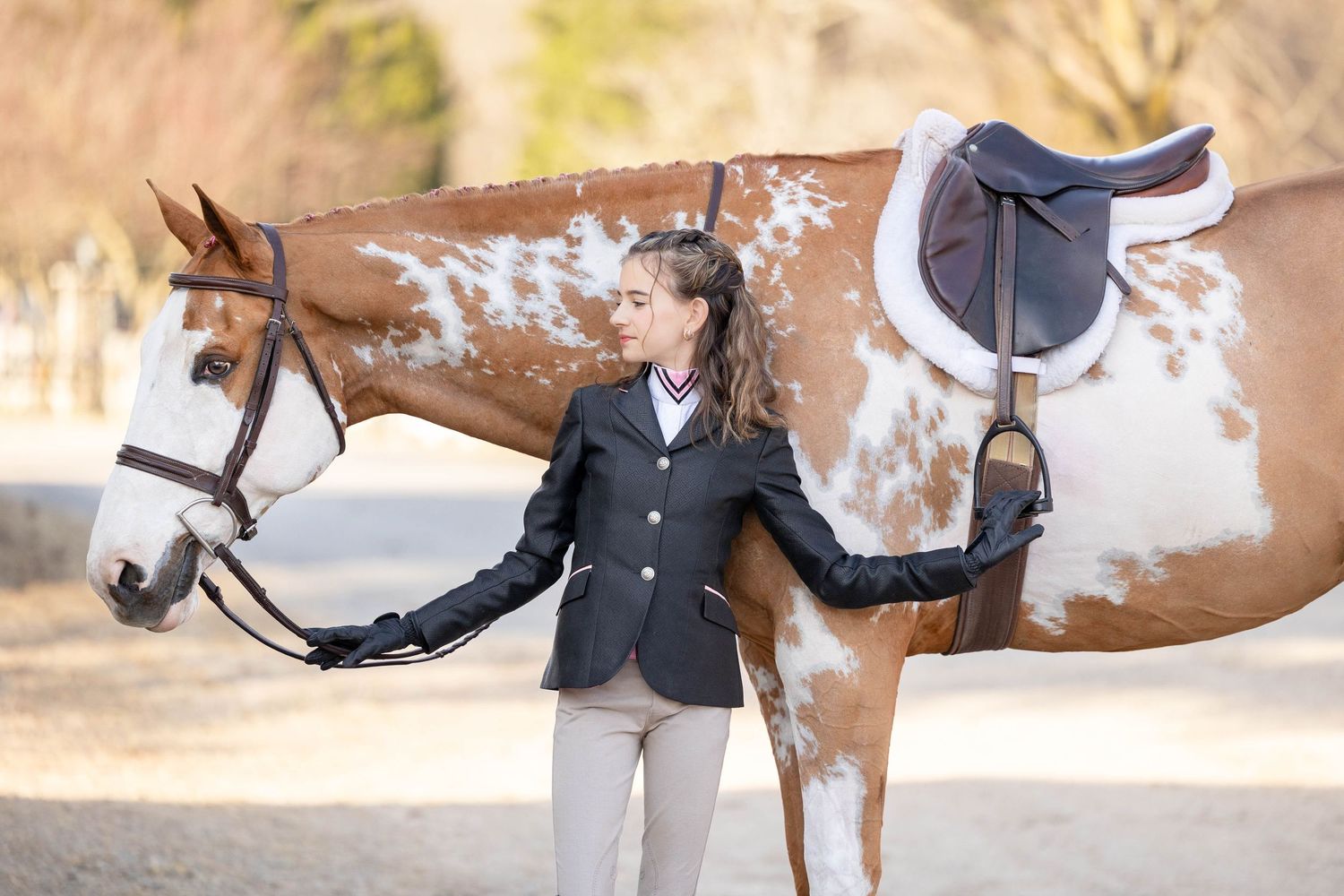 girl with large paint horse in english show clothes