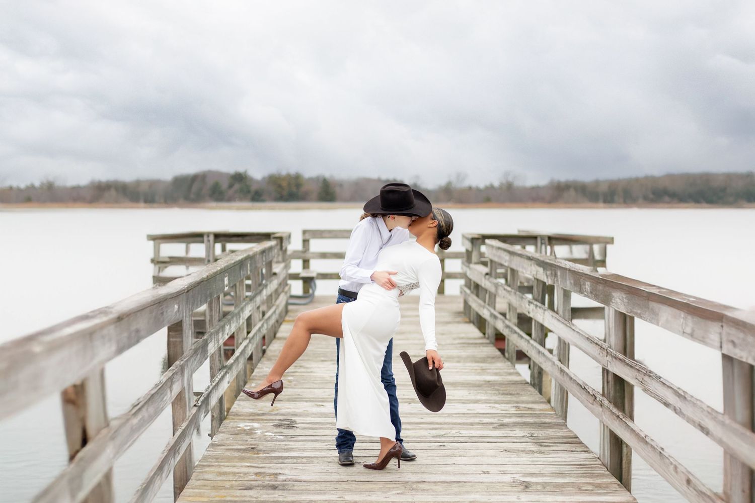 couple engagement shot dip on pier