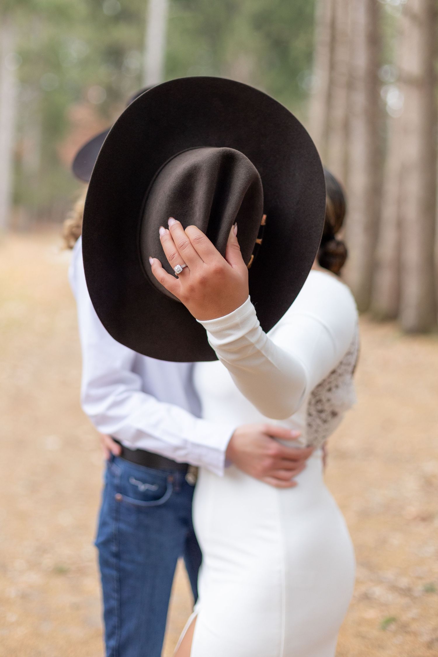 couple engagement shot with western hat