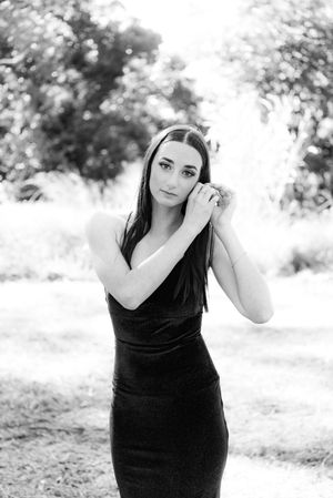 Black and white portrait series in a natural outdoor setting with soft lighting.