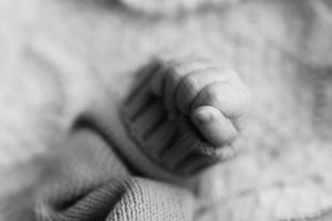 Black and white newborn photography with focus on tiny details.
